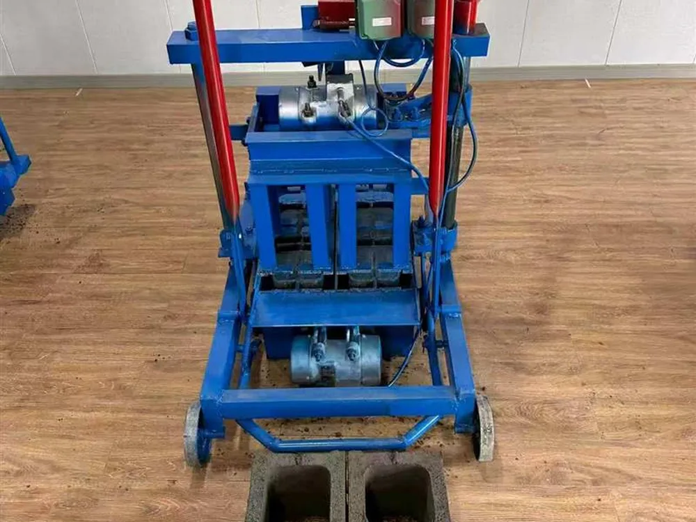 Egg laying block machine on construction site producing concrete blocks on ground